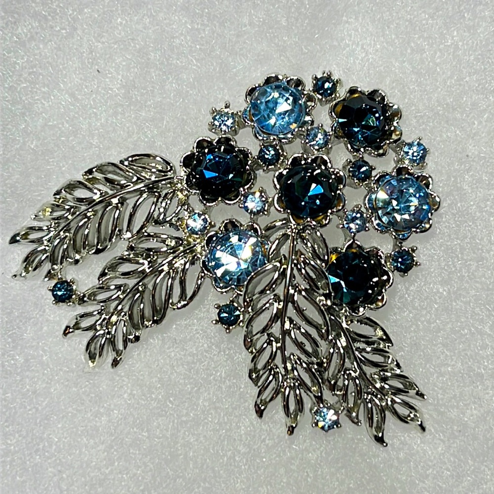 Vintage floral dark blue/light blue stones.  Silver plated. Never worn